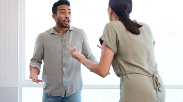 Shot of a young couple looking frustrated and arguing at home